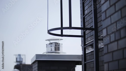 Metal safety ladder on brick building exterior