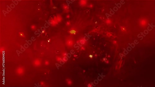 Spinning red abstract particles floating and glowing with soft bokeh effect