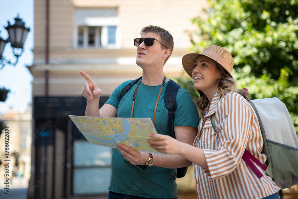 Naklejka premium Couple exploring city street pointing enjoying travel