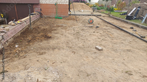 Construction site preparation in a residential backyard during the day