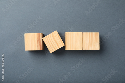Wooden cubes on grey background, top view