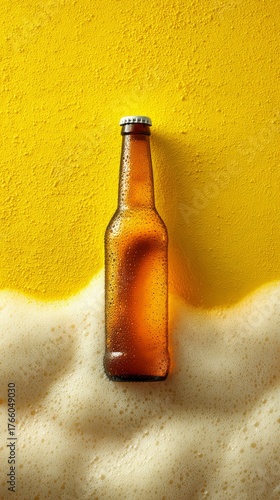 Brown Beer Bottle With Droplets on Yellow Foam Background in Bright Light