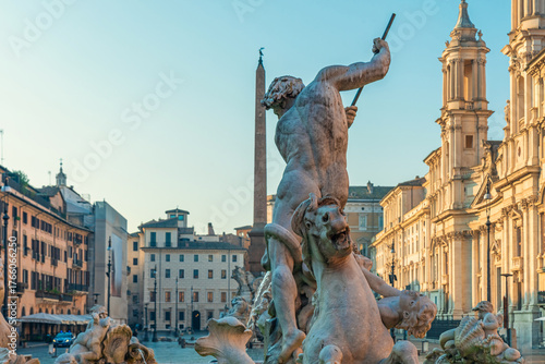 Canvas Print Close up of Neptune sculpture in Fountain of Neptune at Piazza Navona with obelisk and historic buildings in Rome, Italy at sunrise