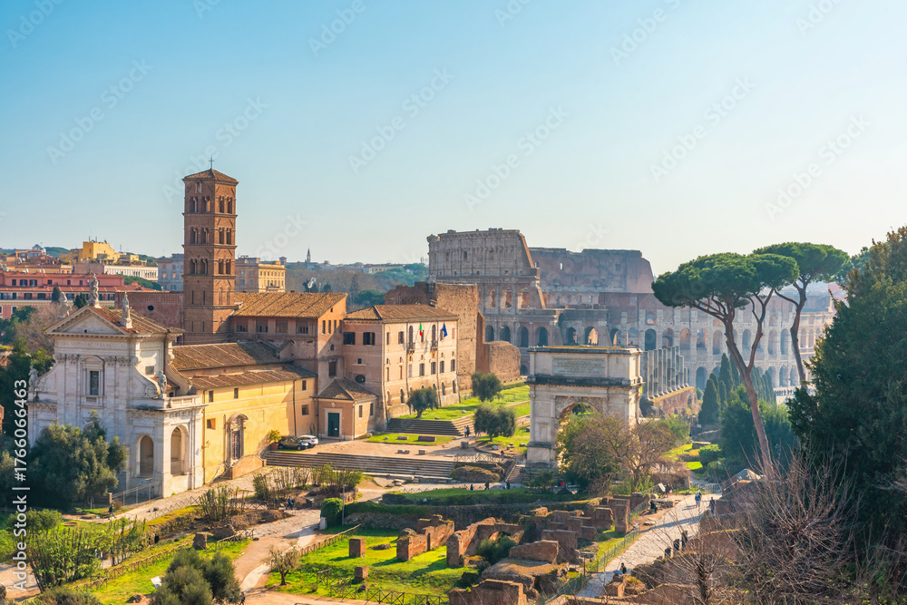 Naklejka premium Aerial view of ancient Colosseum Amphitheater in Rome city, Italy illuminated by soft morning light at sunrise. Italian architecture. Popular touristic and travel landmark