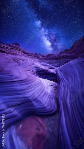 Wavy purple sandstone canyons glow under a vibrant starry night sky with the Milky Way