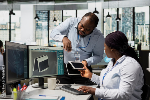 Wallpaper Mural Manager checking work done by employee upgrading solar gadget to support green technology adoption. Team leader and product designer test solar cells prototype, working on clean energy innovations Torontodigital.ca