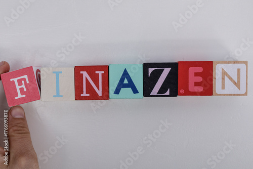 Wooden blocks spelling FINA...