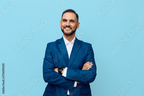 Tapeta A confident professional man stands against a solid colored backdrop, dressed in a tailored suit