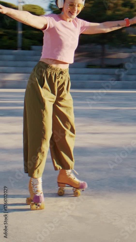 Smiling woman shows moves with quad skates and listens to music