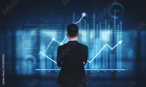 Photography A businessman stands before digital financial data visualization, analyzing trends and metrics