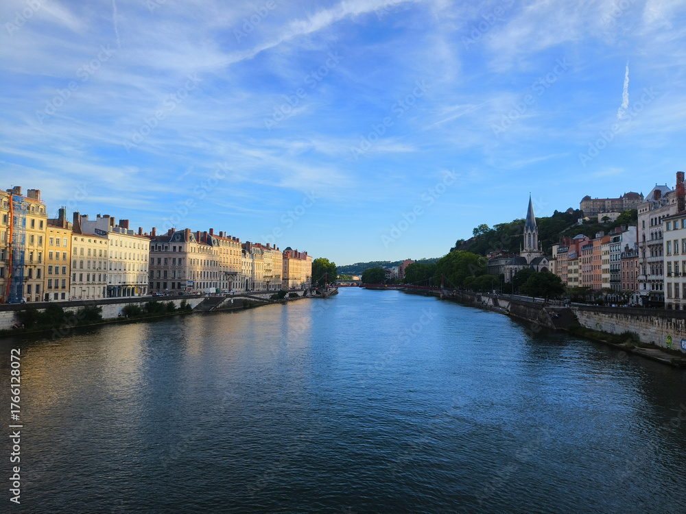 Obraz premium Lyon, France, May 29, 2025, View of the Rhone River and its embankment, waterfront Blue Sky