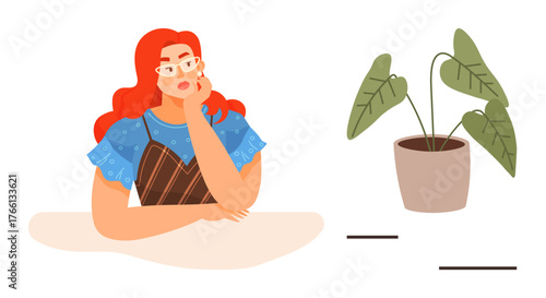 Red-haired woman in blue top sits at table, thinking deeply beside a potted plant. Ideal for themes of creativity, introspection, decision-making, mindfulness, relaxation, inspiration, personal