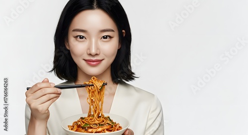 Beautiful Asian Woman Enjoying Spicy Noodles with Chopsticks