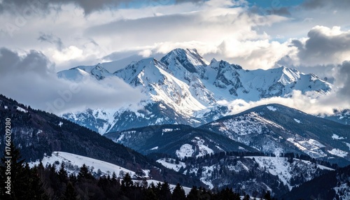 Wallpaper Mural Snow Covered Mountain Peaks Under Dramatic Clouds During Golden Hour With Pine Forest In The Foreground Torontodigital.ca