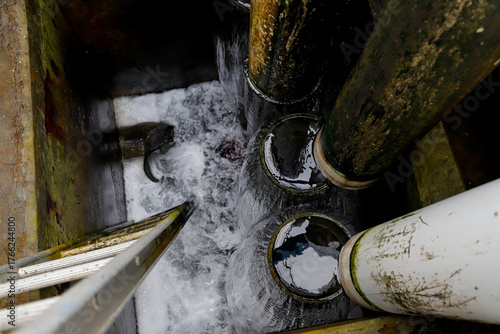 Wastewater Discharge from Industrial Drain Pipe into Sewer System