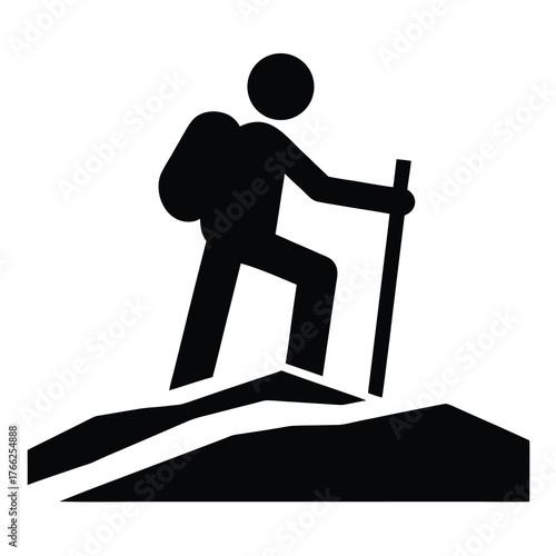 Silhouette of a hiker with a backpack and trekking pole ascending a rocky incline