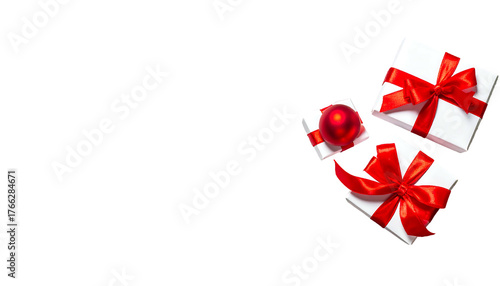 White gift boxes with bright red ribbon and a red ornament, set against a stark black backdrop
