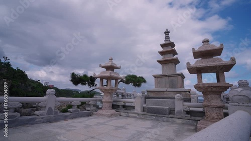 Haedong Yonggungsa Temple features traditional Buddhist pagodas and stone lanterns by the ocean