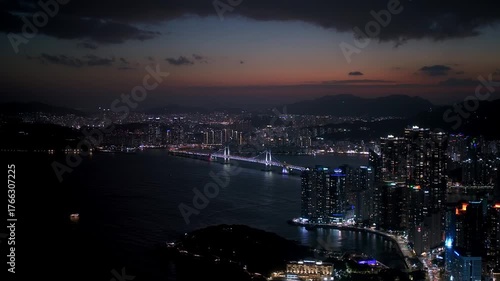 Busan cityscape at dusk with Gwangandaegyo bridge illuminating the bay and urban skyline