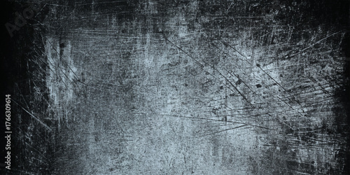 A wall textured surface by a deep gray color with varying shades scuffs, and a mottled, worn out appearance.