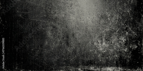 A wall textured surface by a deep gray color with varying shades scuffs, and a mottled, worn out appearance.