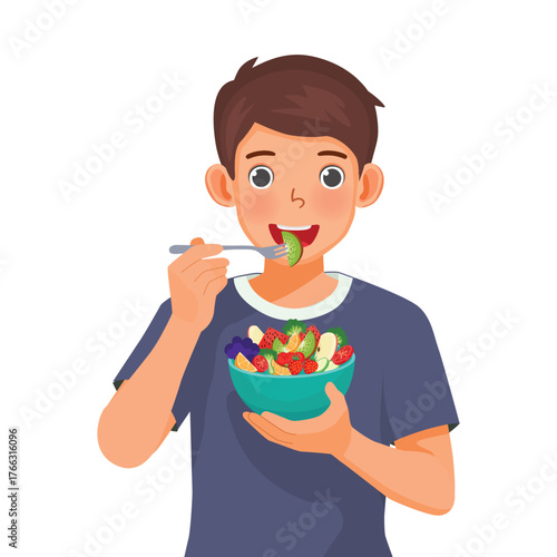Man eating salad from a bowl of fruits and vegetables