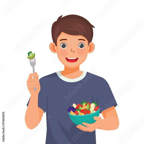 Man eating salad with a fork while holding a bowl of salad