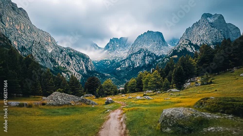 A serene mountain landscape with a path winding through lush green fields and majestic peaks