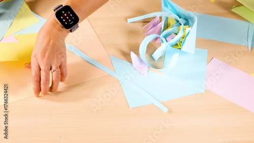 Folding Colorful Origami Paper on Wooden Table