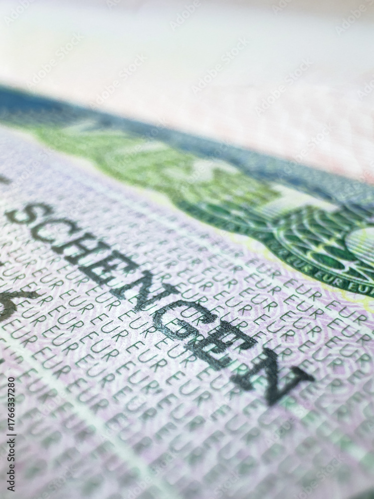 Obraz premium Schengen Visa in passport for world travel, EU visa for Italy, Immigration to England, illegal migrants, tour, airport, customs, news, closed borders, nationality. Macro photo. High quality photo