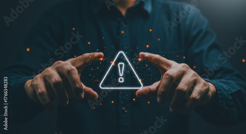 A person's hands delicately cradle a glowing attention sign, conveying a sense of vigilance and the presence of danger. The composition, set against a dark background.