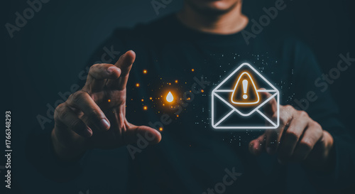 The hands of a person touch the warning sign about a suspicious email with a digitally crafted interface in a dark environment.
