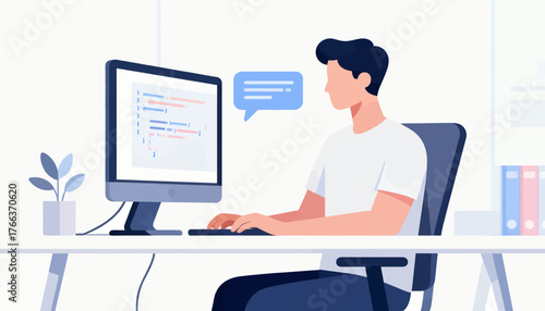 A man is sitting at a desk with a computer monitor and keyboard in front of him. He is typing on the keyboard and he is focused on his work. Concept of productivity and concentration