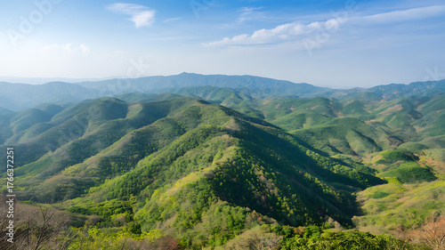 mountain landscape, green valley, blue sky, clouds, winding path, scenic view, nature landscape, mountain scenery, outdoor travel, hiking trail, lush greenery, natural beauty, mountain