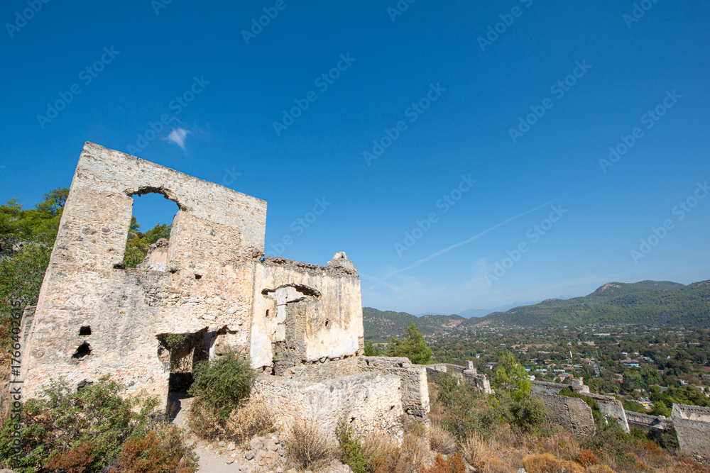 Fototapeta premium Fethiye Kayaköy stone houses and ruins. Mugla, Turkey. Kayakoy ghost village. Turkey's abandoned houses. The Ghost Town of Kayakoy. Abandoned religious ghost city.