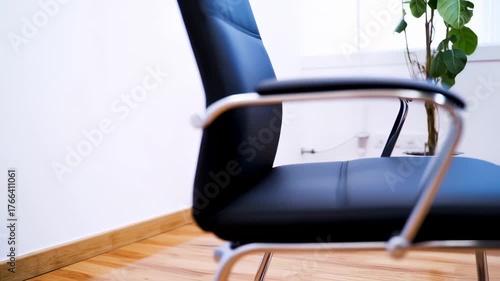 Elegant Black Office Chairs with Chrome Frames in a Modern Work Environment