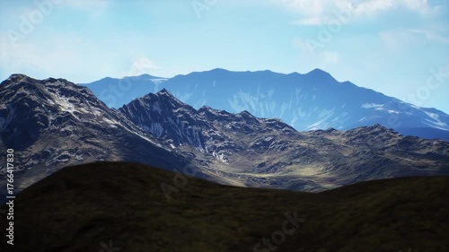 Wallpaper Mural The vast mountain range features dramatic peaks and valleys under a bright sky. The sunlight highlights the intricate formations and colors of the rocky landscape, creating a stunning view. Torontodigital.ca