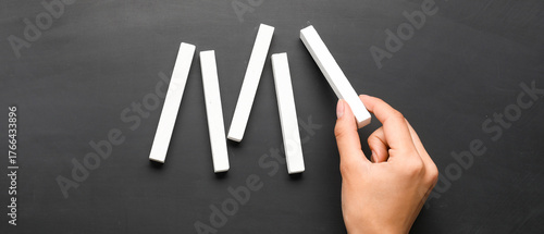 Woman with white chalks on ...
