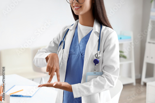 Female doctor using sign la...