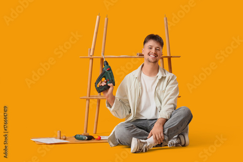 Young man with drill assemb...