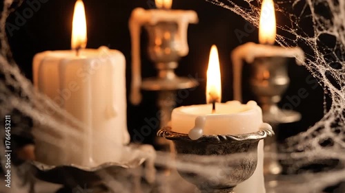 Spooky Halloween candles glow with eerie cobwebs and dripping wax for a haunting atmosphere.