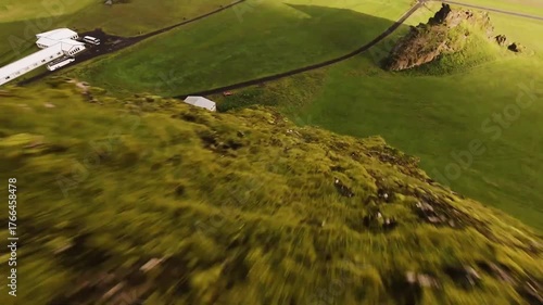 FPV drone surfing down a vibrant green mountain in Ieland.