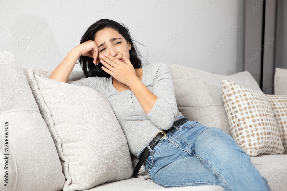 Fototapeta premium sad woman sitting in sofa