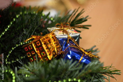 Miniature Christmas Gift Ornaments on Fir Branches Close-up