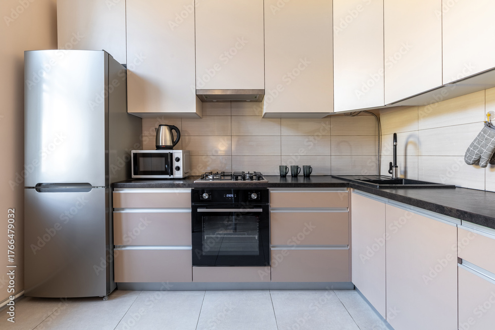 Fototapeta premium Modern Minimalist Kitchen with Beige Cabinets and Appliances