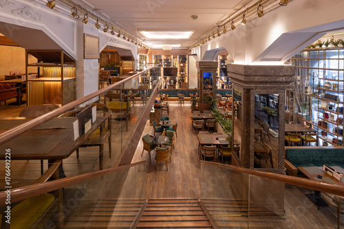 Wallpaper Mural Warmly lit restaurant with chandeliers, wood accents, and two-level layout Torontodigital.ca