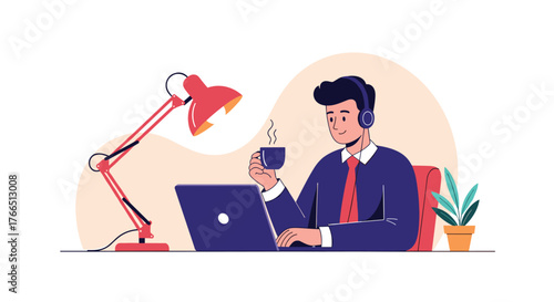 Young man in headphones and business attire drinking coffee while working on a laptop at his desk.
