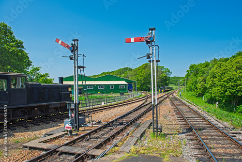 Old heritage diesel train on tracks in rural countryside setting