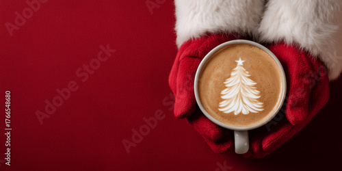 Santa claus hands in red gloves holding a mug of coffee with cheerful christmas tree latte art, symbolizing holiday warmth copy space