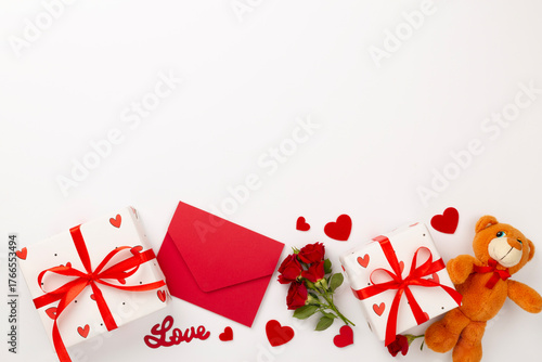 Valentine's Day composition with gifts and red roses on white background, top view
